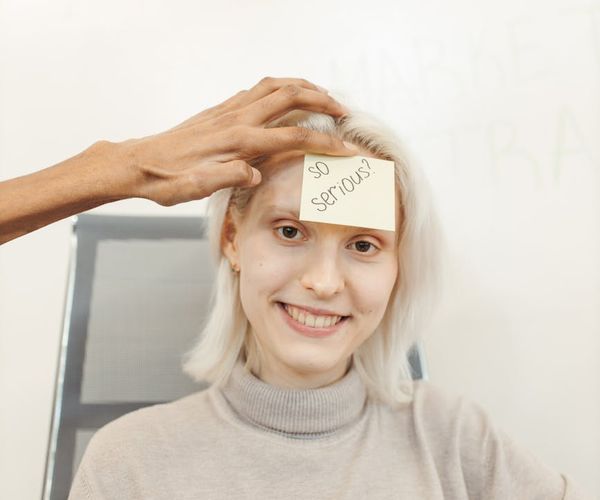 Smiling office worker doing a simple chair twist exercise.